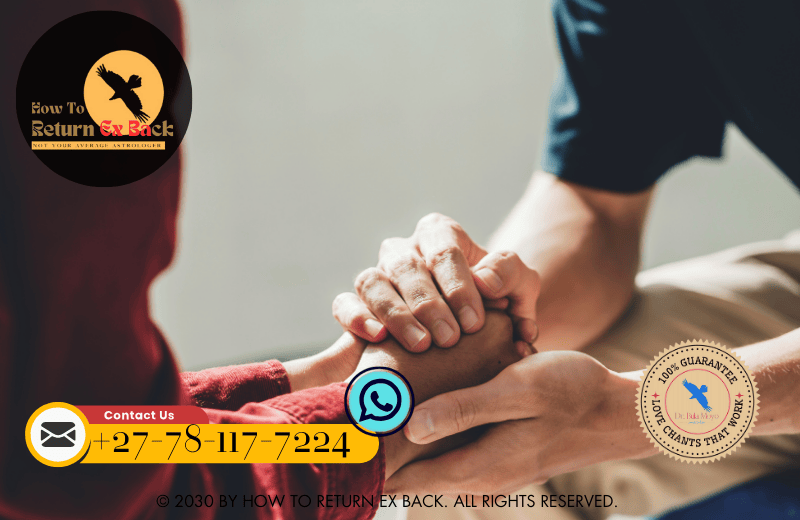 A couple holding hands over a lit candle, symbolizing their commitment to rebuilding trust through rituals.