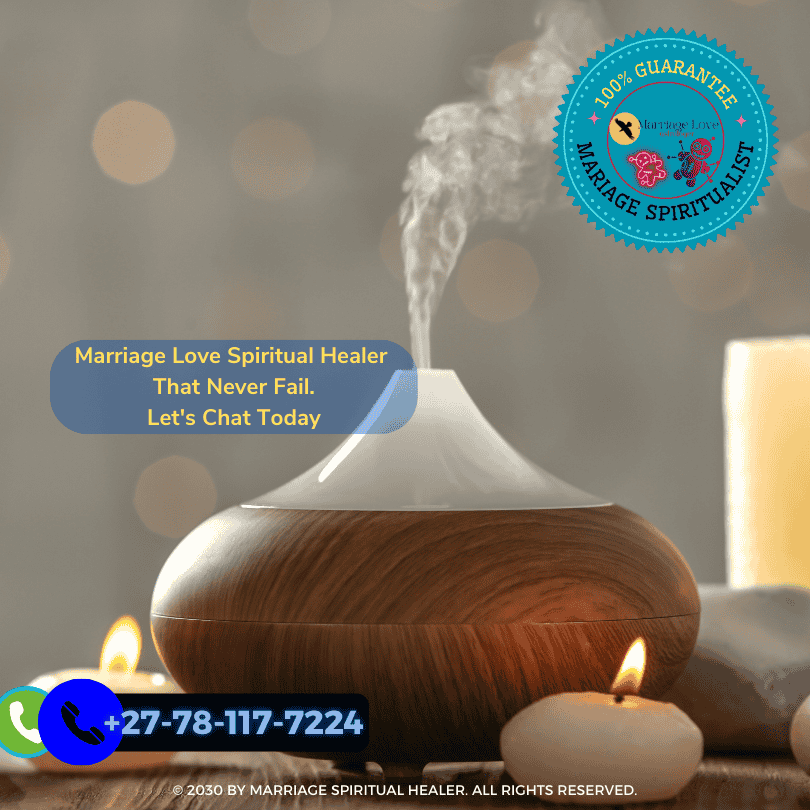 Image shows a person carefully pouring melted red wax into a candle mold with herbs and essential oils on the table