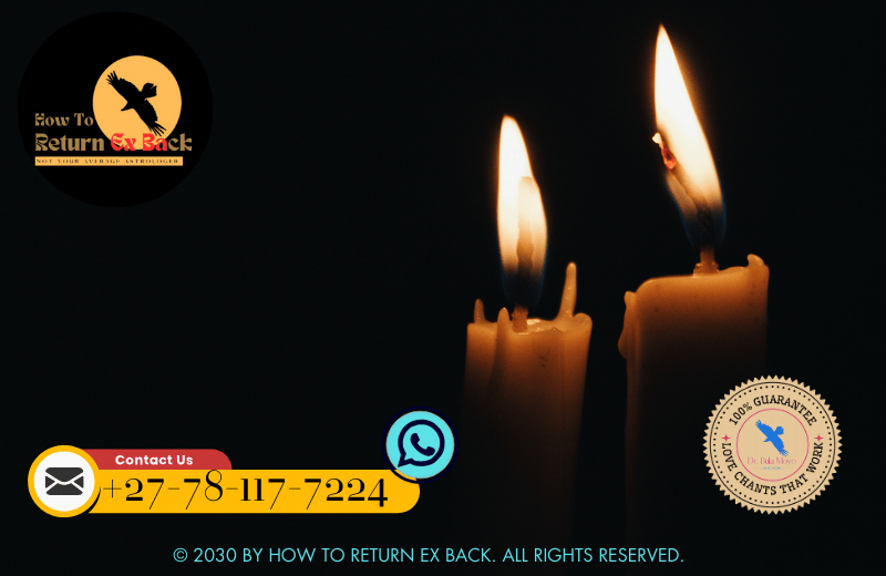 Two candles glowing softly in a dimly lit room, representing a candle lighting ceremony for strengthening bonds.